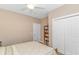 Bright bedroom with a ceiling fan and a bed, along with a closet and a bookshelf at 256 Maple Oak Dr., Conway, SC 29526