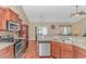 Kitchen showcases stainless steel appliances, granite countertops, wooden cabinets, and connects to the dining and living areas at 256 Maple Oak Dr., Conway, SC 29526