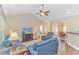 Open-concept living room showcasing comfortable furniture, a ceiling fan, and seamless flow into the dining area at 256 Maple Oak Dr., Conway, SC 29526