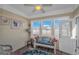 Cozy sun room with a sitting bench, decorated with pillows, three windows and light yellow walls at 256 Maple Oak Dr., Conway, SC 29526