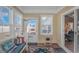 Cozy sun room with bench, decorated with pillows, an electric fireplace, and a glass door at 256 Maple Oak Dr., Conway, SC 29526