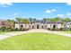 Stunning home exterior with lush green lawn, circular driveway, palm trees, and stone accents at 2849 Old Bryan Dr., Myrtle Beach, SC 29577