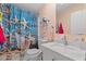 Bathroom featuring a blue starfish themed shower curtain, white marble sink, and tiled floor at 287 Kanawha Trail, Longs, SC 29568