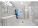 Bright, updated bathroom featuring marble counters, a glass-enclosed shower, and stylish white cabinetry at 287 Kanawha Trail, Longs, SC 29568