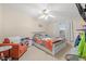 Bright bedroom with large bed, ceiling fan, and chair by the window at 287 Kanawha Trail, Longs, SC 29568