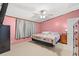 Carpeted bedroom featuring a ceiling fan, gray curtains, and a colorful patchwork quilt on the bed at 287 Kanawha Trail, Longs, SC 29568