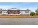 Charming single-story home with a screened porch and well-maintained lawn on a sunny day at 287 Kanawha Trail, Longs, SC 29568