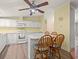 Cozy kitchen with white cabinets, marble countertops, and breakfast bar with stools at 287 Kanawha Trail, Longs, SC 29568