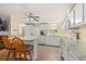 Bright kitchen with white cabinetry, marble countertops, and breakfast bar seating at 287 Kanawha Trail, Longs, SC 29568