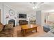 Open-concept living room with fireplace, TV, and view into the kitchen and dining area at 287 Kanawha Trail, Longs, SC 29568