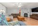 Spacious living room with fireplace, ceiling fan, comfortable seating, and hardwood floors at 287 Kanawha Trail, Longs, SC 29568