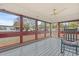 Relaxing screened-in porch with ceiling fan and rocking chair at 287 Kanawha Trail, Longs, SC 29568