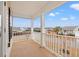 Spacious balcony with white railing overlooking a neighborhood and blue skies at 3000 Chesterwood Ct., Myrtle Beach, SC 29579