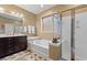 Well-lit bathroom featuring a soaking tub, glass-enclosed shower, and double vanity sink at 3000 Chesterwood Ct., Myrtle Beach, SC 29579