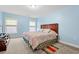 Bright bedroom with a large bed, carpet flooring, and natural light from two windows at 3000 Chesterwood Ct., Myrtle Beach, SC 29579