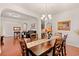 Dining room featuring an elegant chandelier, hardwood floors, an archway, and a view into other rooms at 3000 Chesterwood Ct., Myrtle Beach, SC 29579