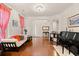 Bright living room featuring hardwood floors, neutral walls, an archway to other rooms, and a piano at 3000 Chesterwood Ct., Myrtle Beach, SC 29579