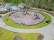 Overhead view of a playground with swingsets and slides, surrounded by sidewalk and grass at 3000 Chesterwood Ct., Myrtle Beach, SC 29579