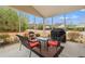 Enclosed screened porch with outdoor seating and a grill, offering a relaxing outdoor space at 3000 Chesterwood Ct., Myrtle Beach, SC 29579