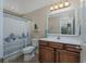 Bathroom with a sink vanity, toilet, and a tub with a stylish shower curtain at 302 Camrose Way, Myrtle Beach, SC 29588