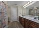 Bright bathroom featuring a double vanity with ample cabinet space and a large mirror at 302 Camrose Way, Myrtle Beach, SC 29588