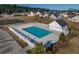 Aerial view of the community pool with a white fence, lush palm trees, and parking in a suburban neighborhood at 302 Camrose Way, Myrtle Beach, SC 29588