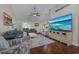 Bright living room with hardwood floors, cozy seating and a large television at 302 Camrose Way, Myrtle Beach, SC 29588