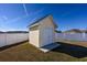 Backyard storage shed in a fenced yard with clear blue sky at 302 Camrose Way, Myrtle Beach, SC 29588