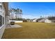 Expansive grassy backyard enclosed by a white fence, perfect for outdoor activities and entertaining guests at 349 Lakota Loop, Longs, SC 29568