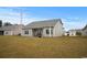 View of the house from the backyard, highlighting the patio area and spacious lawn at 349 Lakota Loop, Longs, SC 29568