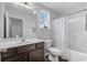 Cozy bathroom features a vanity with a dark wood cabinet, a tub/shower combo, and a window at 349 Lakota Loop, Longs, SC 29568