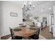 Elegant dining area with wood table and view into the spacious living room and modern kitchen at 349 Lakota Loop, Longs, SC 29568