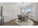 Bright dining area features a modern chandelier, a round wooden table, and natural light from the window at 349 Lakota Loop, Longs, SC 29568