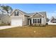 Charming single-story home with a two-car garage and neutral colored vinyl siding at 349 Lakota Loop, Longs, SC 29568