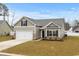 Charming single-Gathering home with a well-manicured lawn, two-car garage, and neutral-tone siding at 349 Lakota Loop, Longs, SC 29568