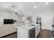 Modern kitchen with island seating, stainless steel appliances, and seamless flow into the living area at 349 Lakota Loop, Longs, SC 29568