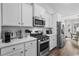 Gourmet kitchen featuring stainless steel appliances, subway tile backsplash, and views of the dining area at 349 Lakota Loop, Longs, SC 29568