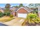 Charming brick home featuring a two-car garage and a well-manicured lawn at 3791 Cagney Ln., Myrtle Beach, SC 29577