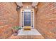 Charming front entryway featuring a brick facade, decorative lighting, and a welcoming door at 3791 Cagney Ln., Myrtle Beach, SC 29577