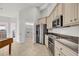 Well-lit kitchen featuring stainless steel appliances, granite countertops, and beige cabinetry at 3791 Cagney Ln., Myrtle Beach, SC 29577