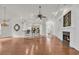 Spacious living area featuring hardwood floors, a fireplace, and an open layout connecting to the kitchen at 3791 Cagney Ln., Myrtle Beach, SC 29577