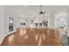 Bright living area with hardwood floors, elegant lighting, and a view of the kitchen and dining spaces at 3791 Cagney Ln., Myrtle Beach, SC 29577