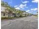 Colorful townhomes with palm trees lining the street, creating a vibrant curb appeal at 3866 Highway 17 Business # C- 9, Murrells Inlet, SC 29576