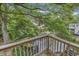 Scenic view of the backyard and canal from the wooden deck, surrounded by lush trees at 3866 Highway 17 Business # C- 9, Murrells Inlet, SC 29576