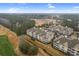 Aerial view of the community shows golf course and pond and residential buildings with parking at 395 S Crow Creek Dr. # 1418, Calabash, NC 28467