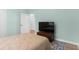 Neutral bedroom with a large TV on a wooden chest for storage in front of open closet space at 395 S Crow Creek Dr. # 1418, Calabash, NC 28467