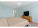 Light-filled bedroom showcasing wood-style flooring, a comfortable bed, and a dresser with a TV at 395 S Crow Creek Dr. # 1418, Calabash, NC 28467