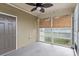 Exterior screened in porch with a ceiling fan, bamboo shade, and storm door entrance at 395 S Crow Creek Dr. # 1418, Calabash, NC 28467