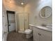 Bright bathroom with shower, toilet, granite vanity, and adjacent laundry at 3955 Gladiola Ct. # 301, Myrtle Beach, SC 29588