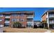 Exterior of brick condominiums with multiple balconies, offering a glimpse of the desirable lifestyle at Azalea Lakes at 3955 Gladiola Ct. # 301, Myrtle Beach, SC 29588